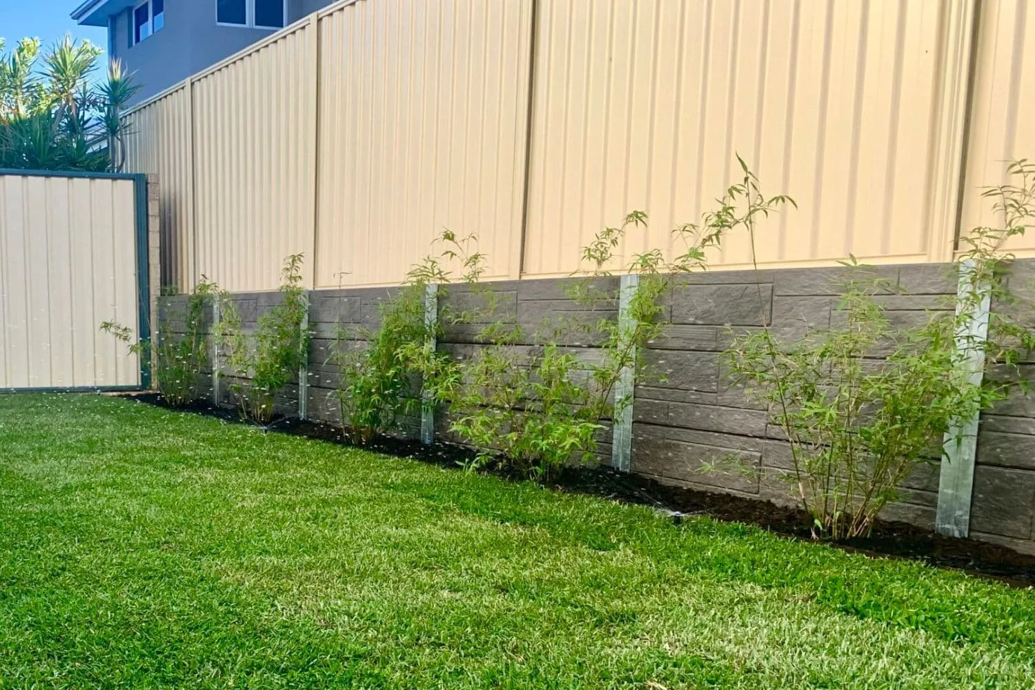 Concrete sleeper retaining wall with garden bed on top