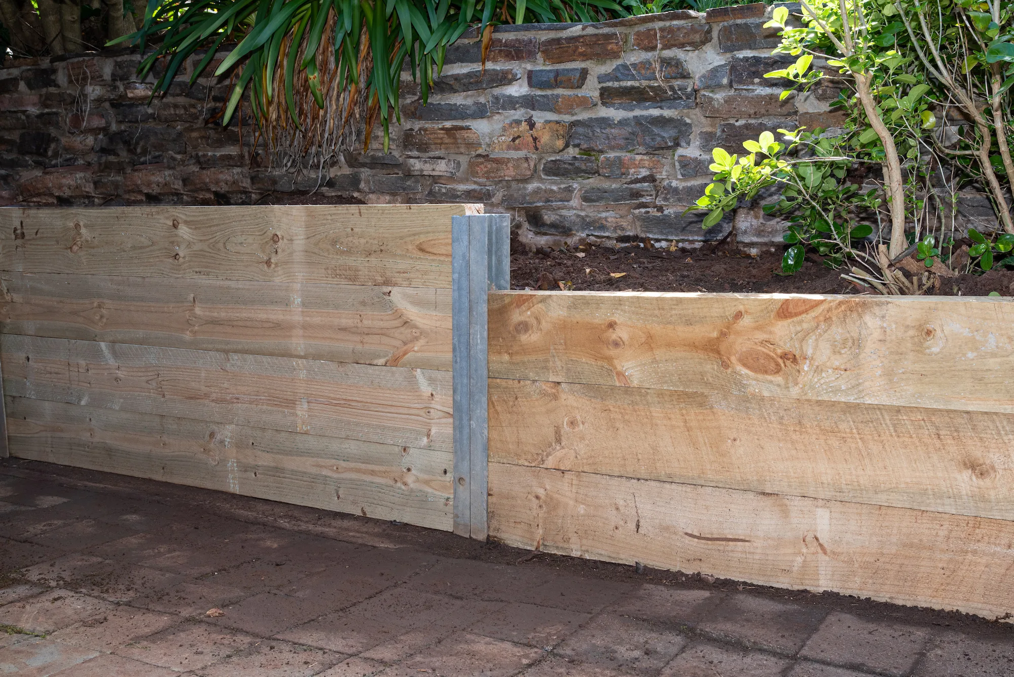 Boundary retaining wall separating two Canberra properties
